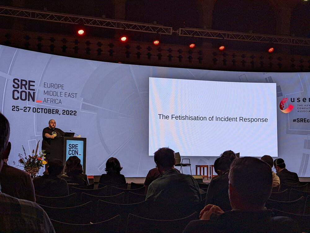 doc standing on stage with a slide saying &ldquo;the Fetishisation of incident response&rdquo;